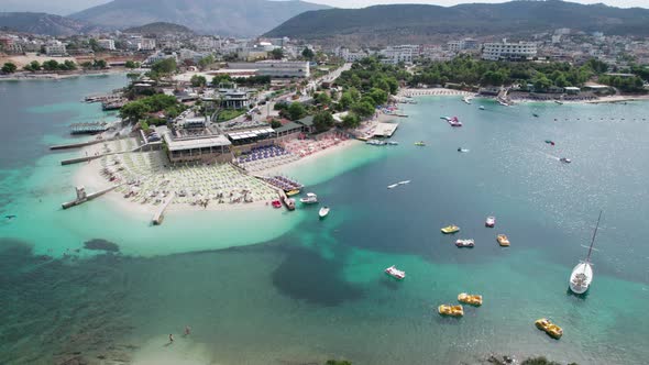 Aerial Azure Beach with Empty Sun Loungers and Boats Balkan Sea Coast Albania alt
