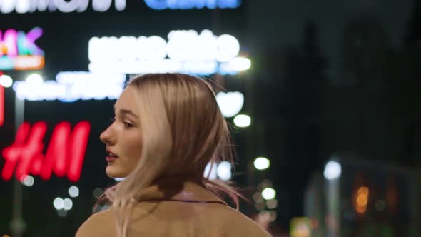 Beautiful Young Girl Blonde Walks Around the Night City