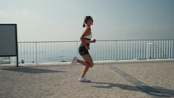 Young Caucasian Woman Running at Seaside alt