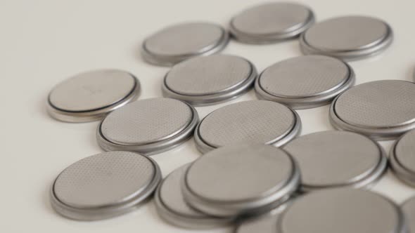 Lot of used button watch batteries slow pan 4K footage alt