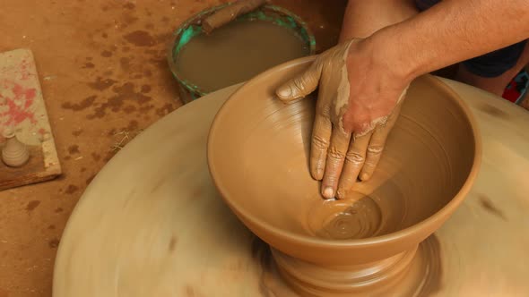 Potter at Work Makes Ceramic Dishes alt