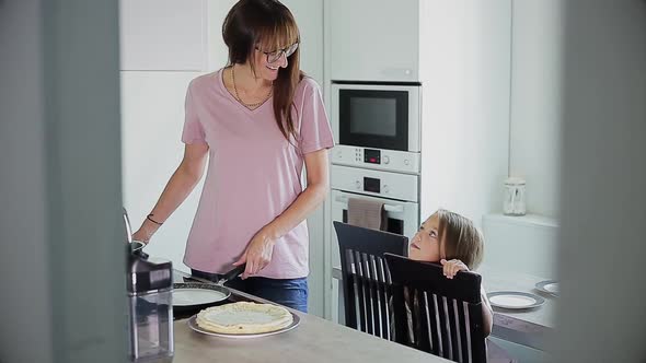 Mother and Daughter Cooking in Kitchen