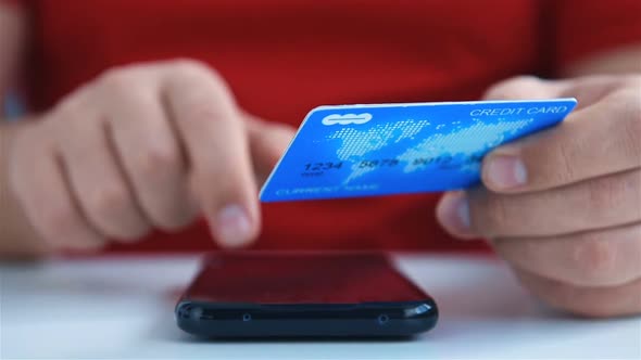 Hands Enters Credit Card Details Into Smartphone To Buy.
