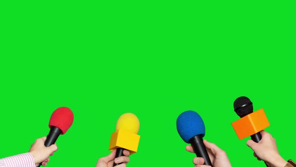 Microphones in the Hands of Journalists for Interview on Green Screen Background alt