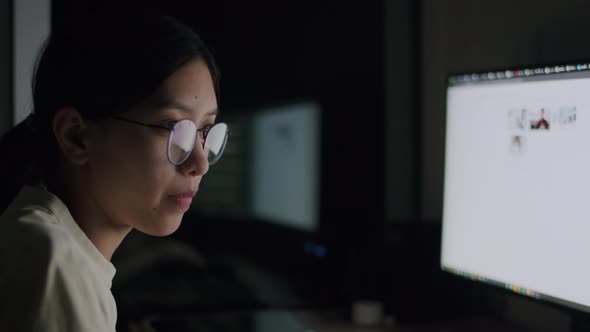 Candid of Asian businesswoman staying late hours in the home office.