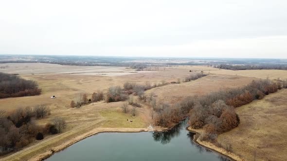 Flying over huge lake in empty fields Missouri. alt