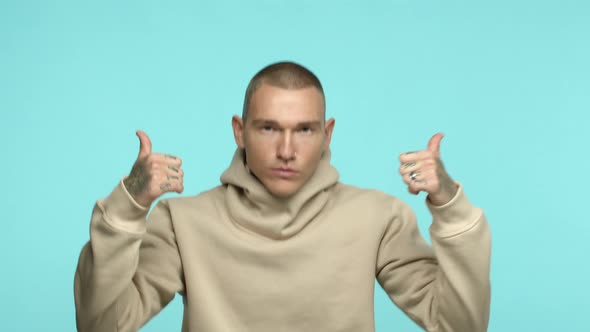 Slow Motion of Stylish Caucasian Man with Tattoos on Shaven Head and Knuckles Jumping From Bottom