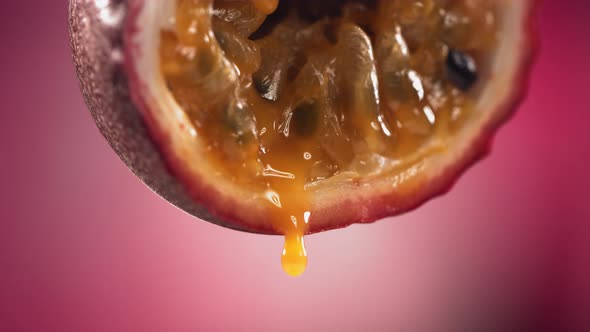 Slow Motion Macro Shot of Flowing Passion Fruit Maracuya Juice From Halved Maracuya alt