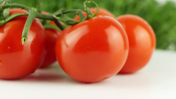 Ripe natural tomatoes close-up. Organic tomato rotating on a green background Macro shot. alt