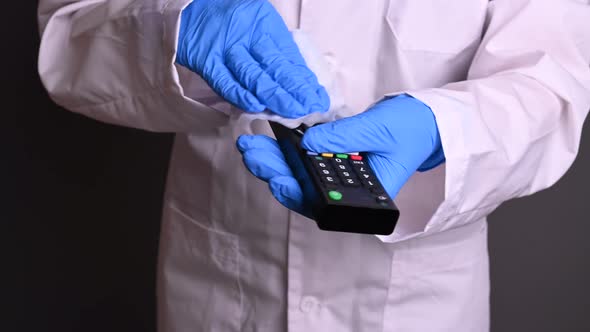 People Deinfection From the Virus. a Man in a Mask and Robe Handles a TV Remote. Protection From alt