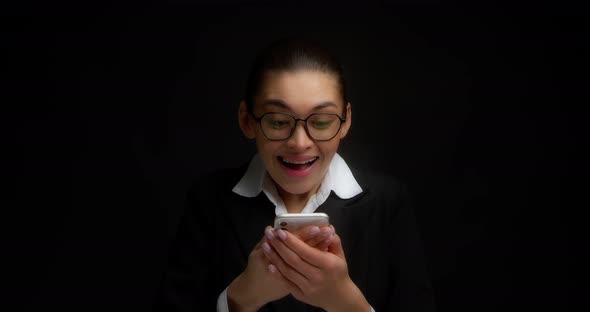 Business Woman Enjoys a Message in Her Smartphone