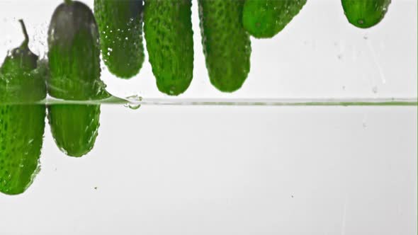 Super Slow Motion Cucumbers Fall Into Water with Splashes alt