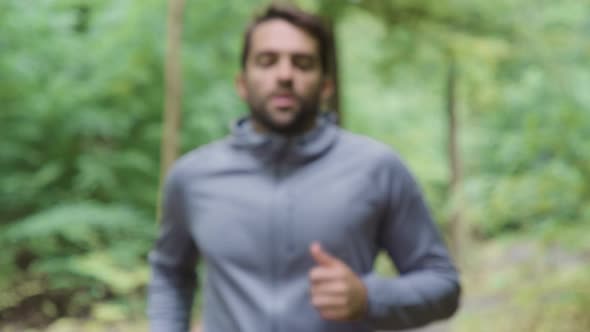 Man Running Into Focus And Wiping Brow