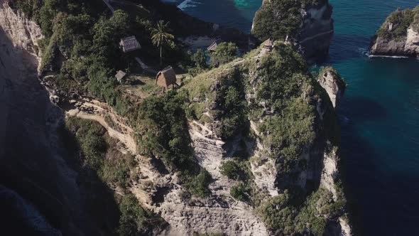 Aerial Fly Over View Of Multiple Tree House Hostels on Cliff 