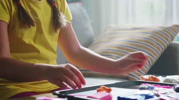 Girl Is Rolling a Piece of Plasticine alt