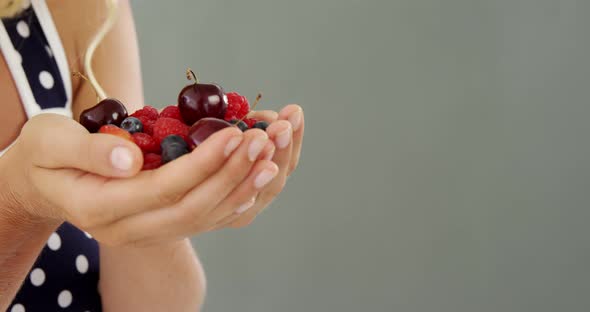 Beautiful woman holding berries alt