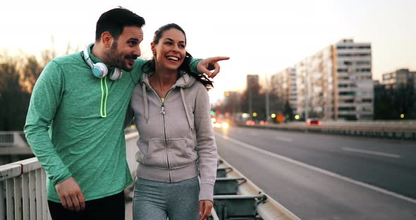 Beautiful Couple Talking After Fitness Exercising and Jogging