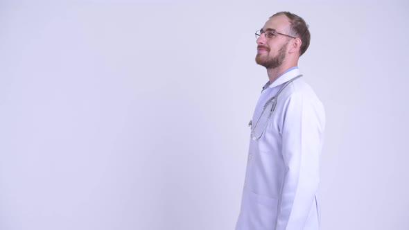 Profile View of Happy Bearded Man Doctor Smiling