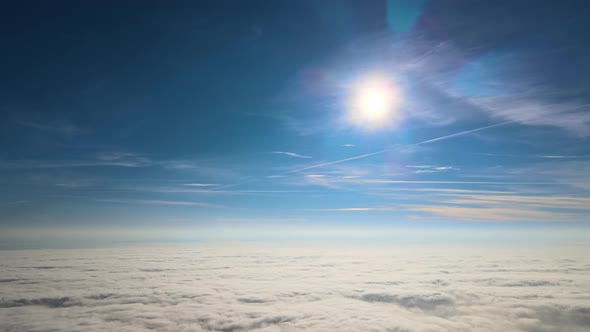 Aerial View From High Altitude of Earth Covered with White Puffy Cumulus Clouds on Sunny Day alt