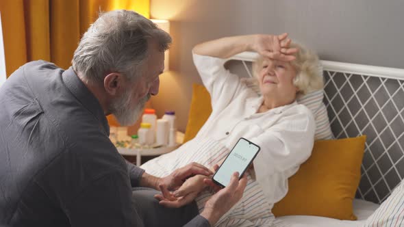 Senior Man Check the Pulse of Sick Wife Lying on Bed alt