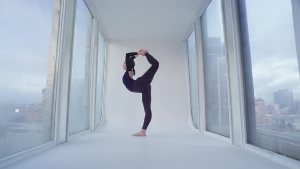 Acrobatic Stretching At The Rooftop Studio With Panoramic Windows And City Skyline