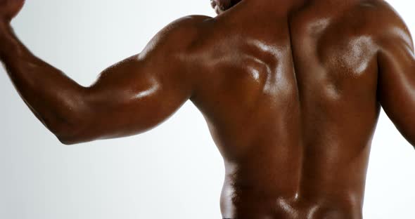 Muscular man flexing his biceps alt