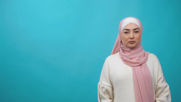 Young Serious Mixedrace Woman with Hijab Looking at Camera