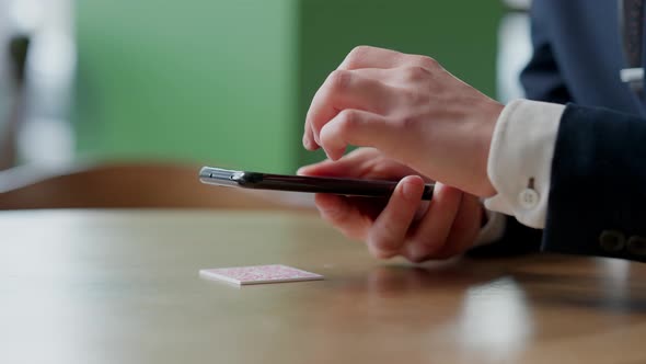 Closeup of Smartphone in Male Hands Tapping on Screen alt