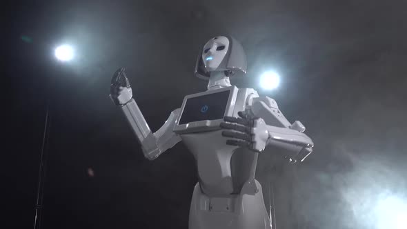 Robot Moves and Gestures with Hands. Black Smoke Background alt