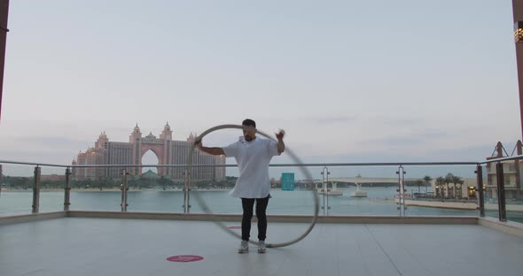 Gorgeous View on Atlantis Hotel in the Background of Wheel Gymnast Performing alt