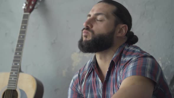 Hungry Street Musician Eating Outdoors in Underground Crossing. Close-up Portrait of Poor Young alt