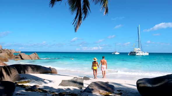 Anse Georgette Praslin Seychelles Young Couple Men and Woman on a Tropical Beach During a Luxury alt