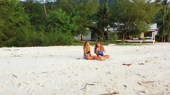 Women relaxing on perfect island beach wildlife by blue water with white sand background of Thailand alt
