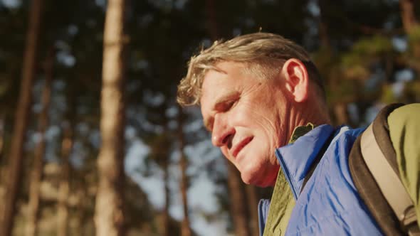 Active senior hiking in forest alt