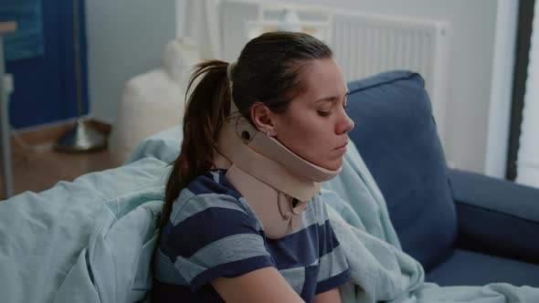 Close Up of Unhappy Woman Wearing Cervical Neck Collar alt