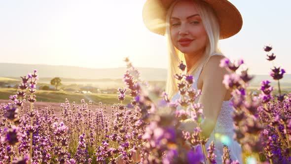 Portrait of a Blonde Woman with Hat in Lavender Fields on Summer