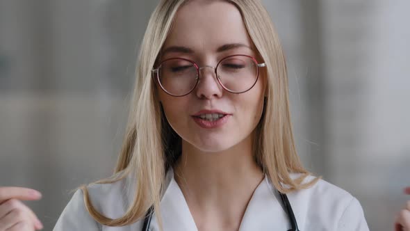 Caucasian Female Doctor Wear Eyeglasses Make Online Video Call in Hospital Clinic Consult Patient alt
