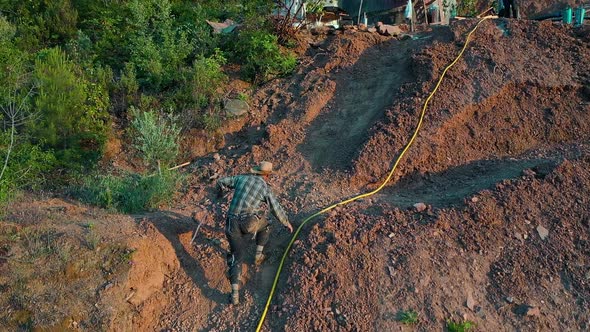 Farmer After Working on the Plantation Aerial View alt
