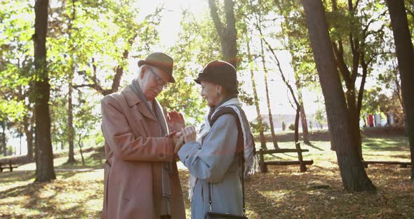 Senior Man Takes Wedding Ring Out of Pocket and Puts It on His Beloved's Finger alt
