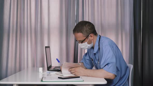 Doctor Writes with Ballpoint Pen Fills Medical Card alt
