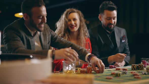 Group Happy People are Talking Make Bets Gambiling in a Casino alt