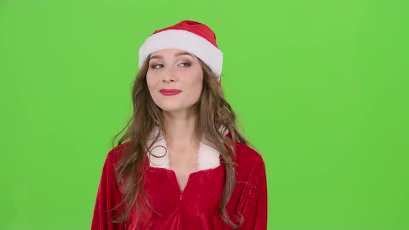 Girl in the Red Suit of the Snow Maiden Winks and Shows Her Finger Ok. Green Screen. Close Up. Slow alt