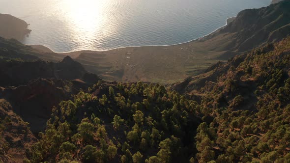 Aerial dolly over sunlit valley Las Playas of the Atlantic ocean coast
