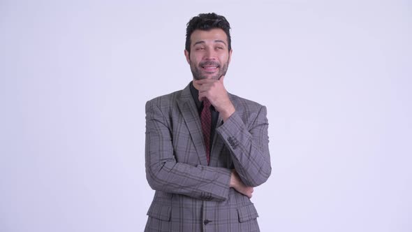 Happy Bearded Persian Businessman Thinking alt