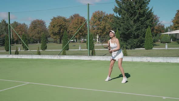 Slow Motion Professional Female Tennis Player Hits the Ball with a Racket Practice Game on the alt