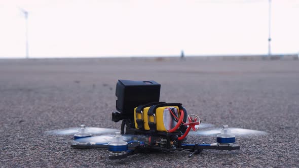 FPV Racing Drone Takes Off From the Asphalt Surface