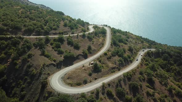 A Winding Road Through the Crimean Mountains Along the Sea alt