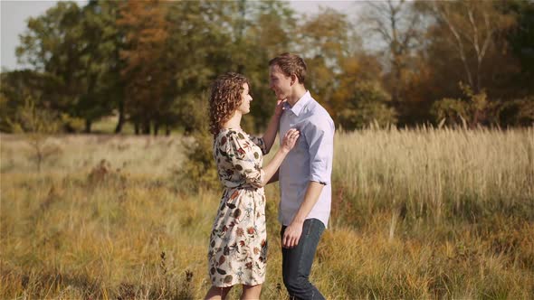 Young Couple in Love Walking on Meadow in Summer - Togetherness Concept alt