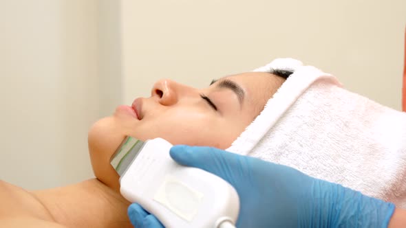 Cosmetologist Peels Woman's Chin alt