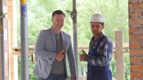 Builder and Foreman on the Construction Site Shake Hands